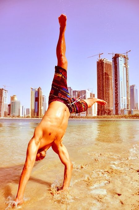 Yufo Trickster in a handstand on the beach